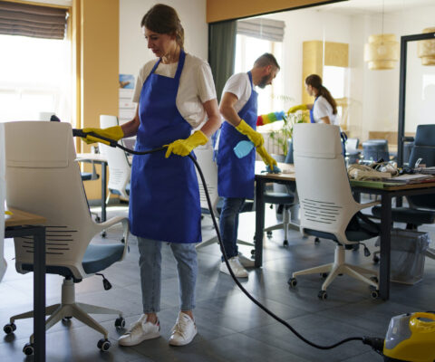 professional-cleaning-service-person-using-vacuum-cleaner-office